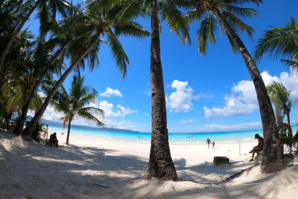 Powdery white sand meets crystal-clear turquoise waters under a sky painted with endless blue. This is Boracay perfection.