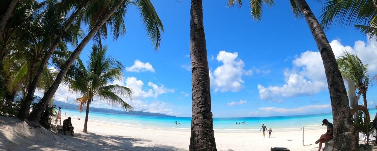 Powdery white sand meets crystal-clear turquoise waters under a sky painted with endless blue. This is Boracay perfection.