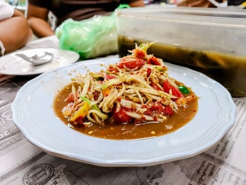 Tam Mak Hoong, a classic green papaya salad from Luang Prabang. This dish is a symphony of flavors - tangy, spicy, and refreshing all at once. It’s not just a salad, it’s a taste of Laos in every bite!