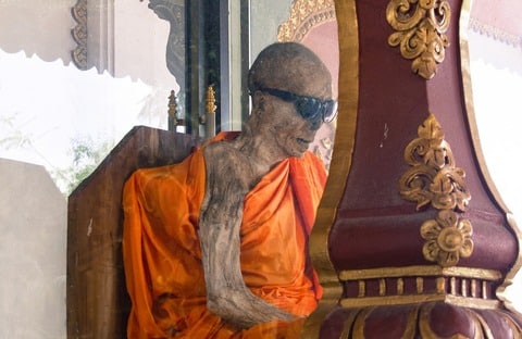 The mummified monk Luong Pordaeng died in 1973 and his body has been on display in a glass case at the temple ever since.